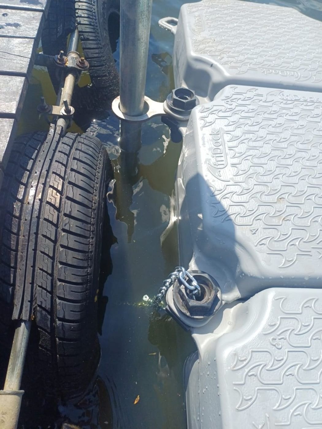 Close-up of galvanised pole and infinity bracket connection on the floating dock