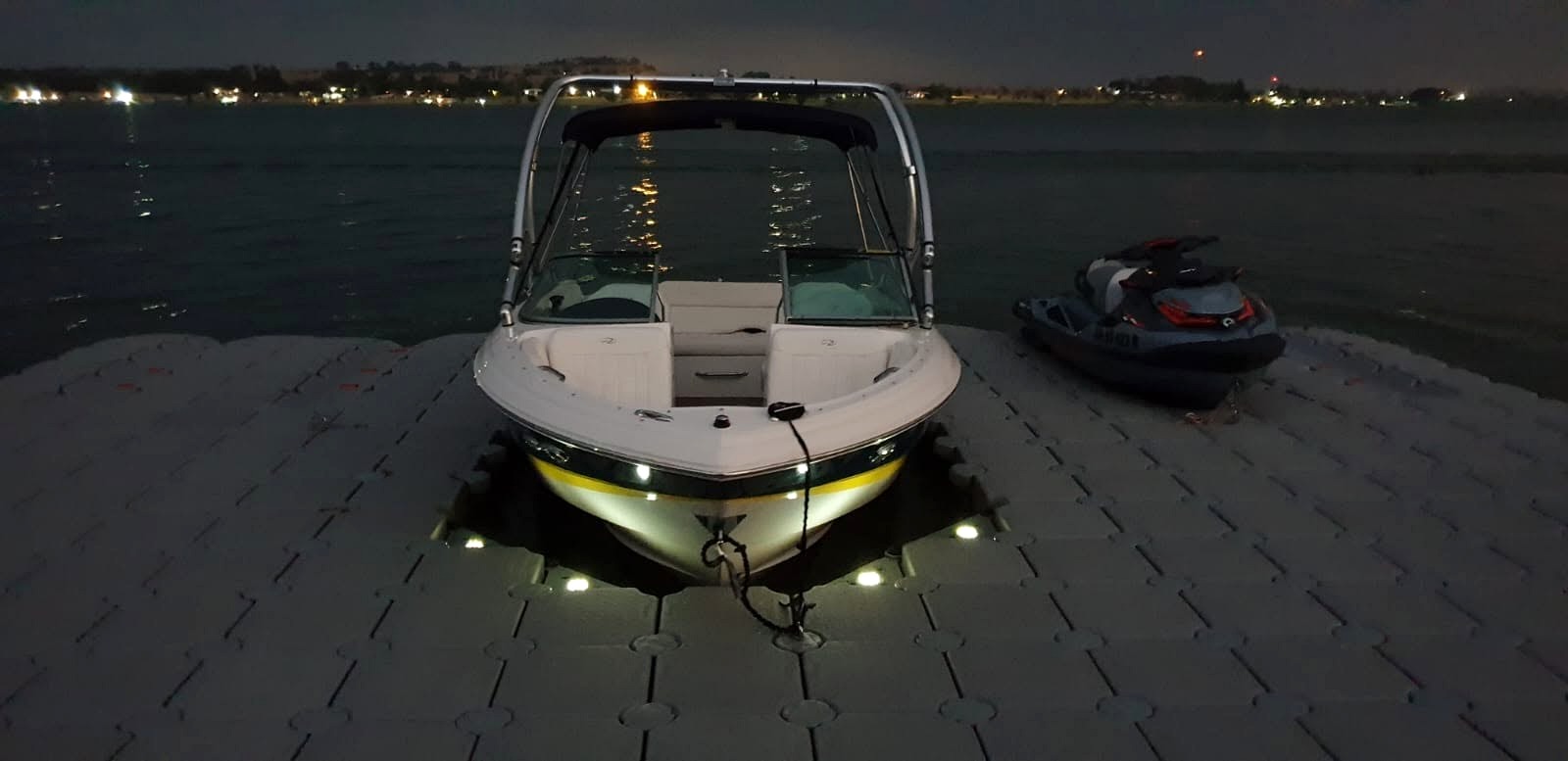 SA Outdoor boat and jet ski on modular floating dock at night